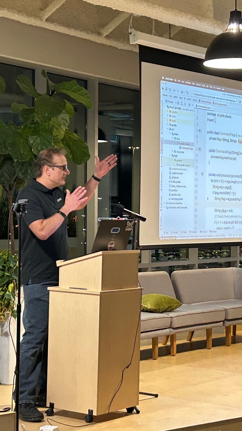 Speaker at podium with code